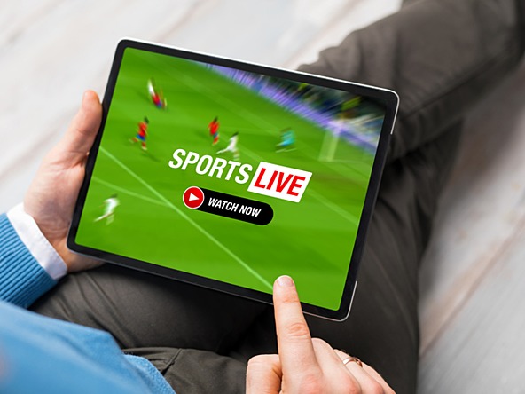 Man watching sports streaming live on digital device